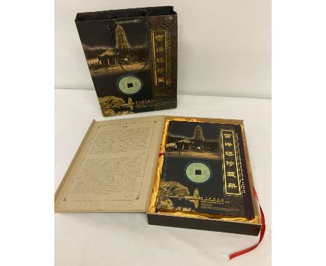 A boxed commemorative album celebrating the rebuilding of the Leifeng Pagoda.  The album contains replicas of ancient copper 