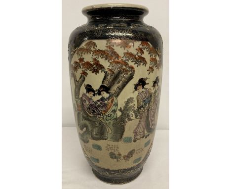 A large oriental black and gold satsuma ceramic vase with panel decoration.  Depicting oriental ladies in a garden.  Approx. 