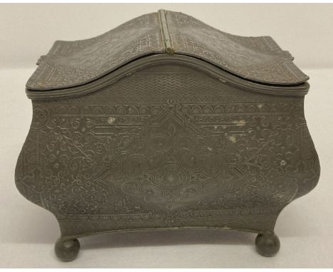 A decorative 2 sectional pewter tea caddy raised on ball feet.   Approx. 11 x 14 x 9.5cm.