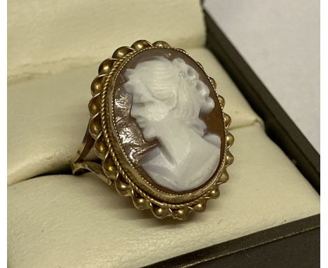 A 9ct yellow gold cameo dress ring. An oval cameo set in gold mount with rope design to outer edge.  Full hallmarks to inside