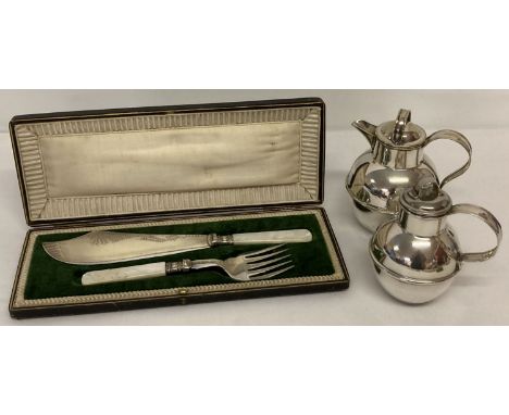 A cased set of fish servers with engraved decoration and mother of pearl handles.  Together with 2 silver plated Jersey style