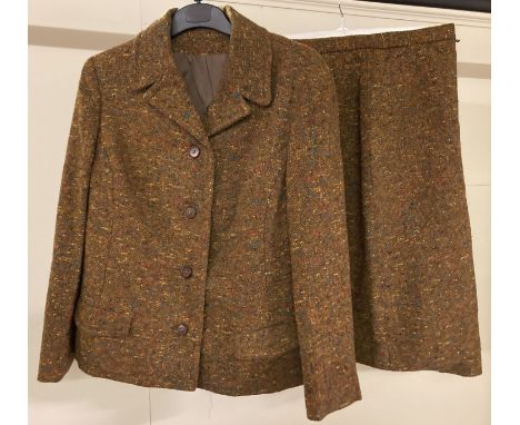 A ladies vintage 2 piece wool skirt and jacket suit.  Rust brown colour with red, blue and yellow flecks throughout. Jacket i