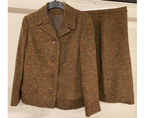 A ladies vintage 2 piece wool skirt and jacket suit.  Rust brown colour with red, blue and yellow flecks throughout. Jacket i