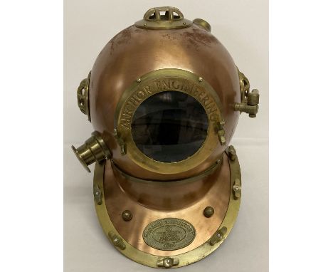 A copper and brass Anchor Engineering divers helmet with glass panels.   Approx. 44cm tall.