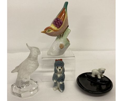 A Hollohaza Hungarian porcelain bird figure with bright colour decoration.  Together with a small glass cockatoo by Nacthmann