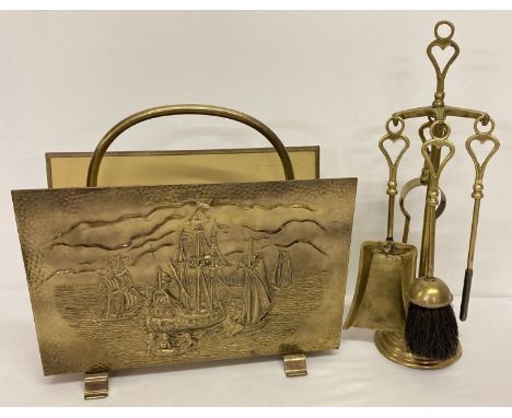 A vintage brass magazine rack with embossed ship decoration together with a vintage brass companion  stand with fireside tool