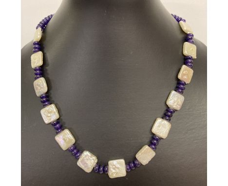 An 18" freshwater pearl and dyed purple quartz beaded necklace with white metal S shaped clasp.  