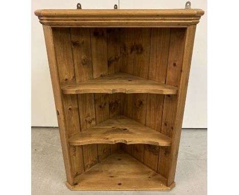 A pine 3 shelf corner wall hanging unit with shaped shelf fronts.   Approx. 76cm tall x 51.5cm wide.