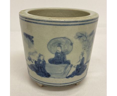 A hand painted blue and white Chinese ceramic brush pot.  Raised on 3 stepped feet. Decorated with figural design.  Approx. 1