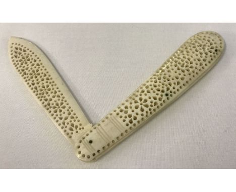A vintage bone letter opener with pierced work decoration throughout.  