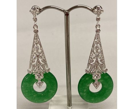 A pair of 925 silver and jade drop earrings.  2.25cm diameter jade disc pendants suspended from a silver mount set with clear