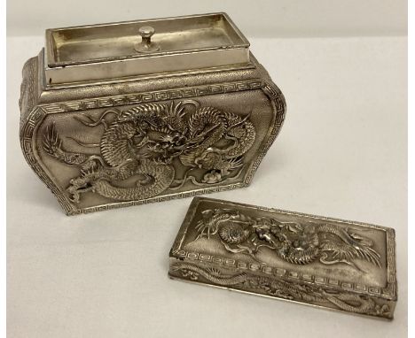 A Chinese decorative metal sarcophagus shaped tea caddy with dragon panel detail.  Complete with interior lid.  Approx. 9 x 1