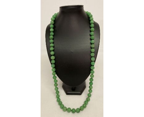 A 32" apple green jade beaded necklace, knotted between each bead.   Beads approx. 1.25cm diameter.