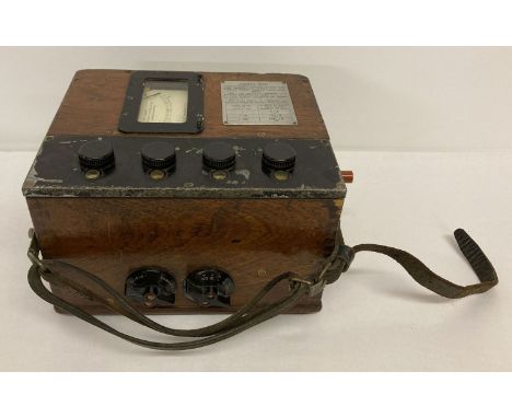 A vintage wooden cased Bridge Ohmmeter meg resistance tester by The Record Electrical Co, Ltd.  Model No. 206260, complete wi