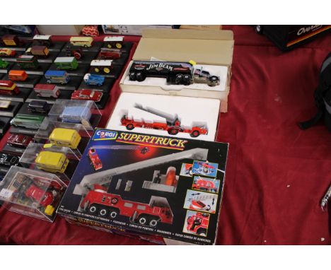 A Corgi Supertruck fire engine set; a Corgi American Le France aerial ladder truck and a Matchbox 200th Anniversary Jim Bean 