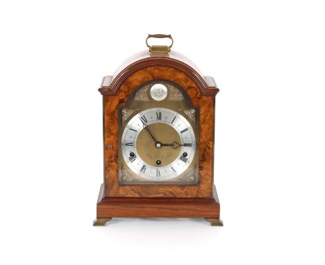A walnut cased Elliott eight day mantel clock with Westminster and Whittington chiming movement, surmounted by a brass carryi