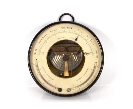 An aneroid barometer in painted metal frame