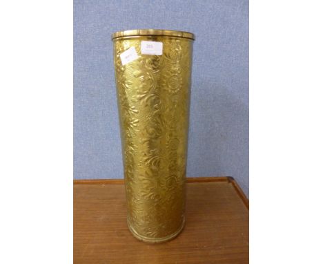 A brass umbrella/stick stand with floral embossed decoration