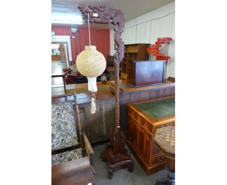 A Chinese carved hardwood standard lamp