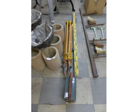 A surveyor's level and tripod with metric staff