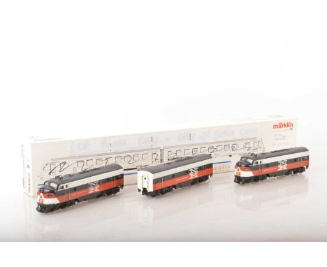 A three-part vintage Marklin HO Gauge 3-rail American New Haven F7 Diesel Locomotive set,  all in NH orange/black/white compr