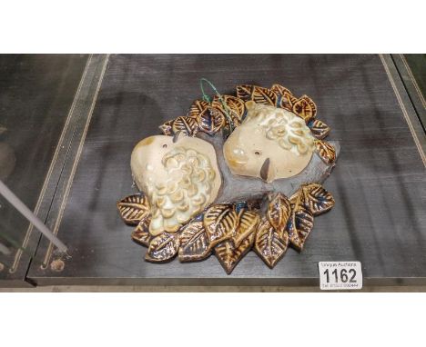 A ceramic wall hanging 2 birds