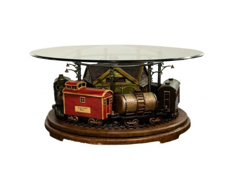 Train Coffee Table with Round Glass Top  Having a train including an engine, tender, (4) cars and a caboose that rotate aroun