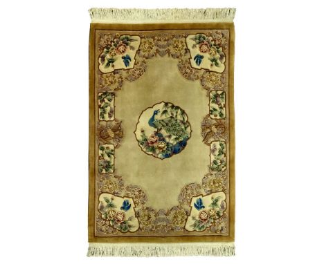 Indian Wool Area Rug  Aubusson style having a center medallion with a peacock and floral motif in hues of beige, tan, green a