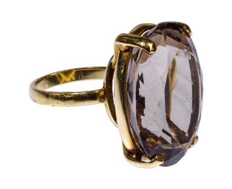 18k Yellow Gold and Smokey Topaz Ring  Having a 26mm by 19mm oval cut smokey topaz; marked '750' inside bandSize: 7.5Weight: 