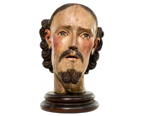 Santo Life-Size Carved Wood Head  Painted, having inlaid ceramic eyes and mounted to a turned wood base; possibly Hispano-Fil