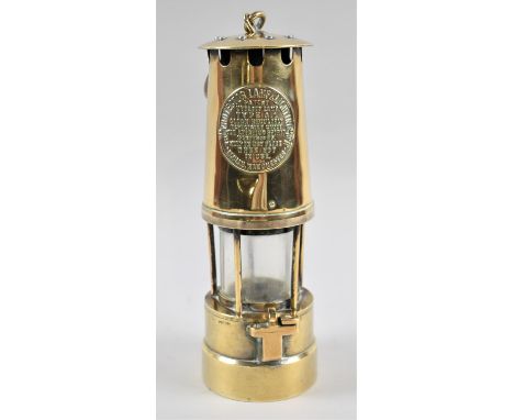 A Brass Miners Safety Lamp by the Protector Lamp and Lighting Co 