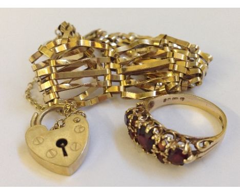 A 9 carat gold gate bracelet together with a 9 carat gold ladies' dress ring set with garnets (bracelet 8.6 grams).