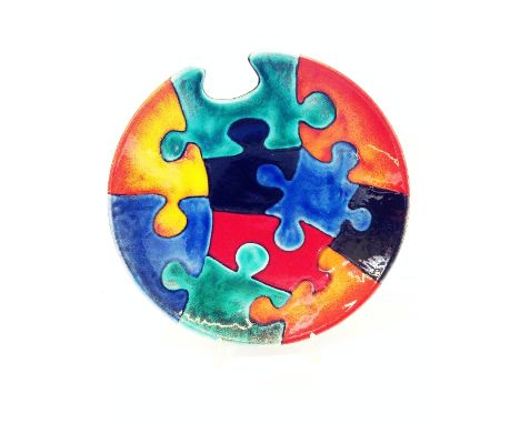 A Poole Pottery Studio, circa 2000, Limited Edition Jigsaw charger, designed and painted by Nikki Massarella, 92/250 (with or