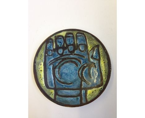 A Poole Pottery Studio pin dish, Shape 49, decorated in colours with the image of a fist, TV backstamp.