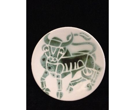 A Poole Pottery Studio pin dish, Shape 49, decorated in tones of green on white ground with the image of a bull, TV backstamp