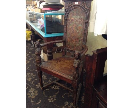 A 19th century oak armchair with painted leather back decorated with a dragon, the arm rests decorated with male and female w