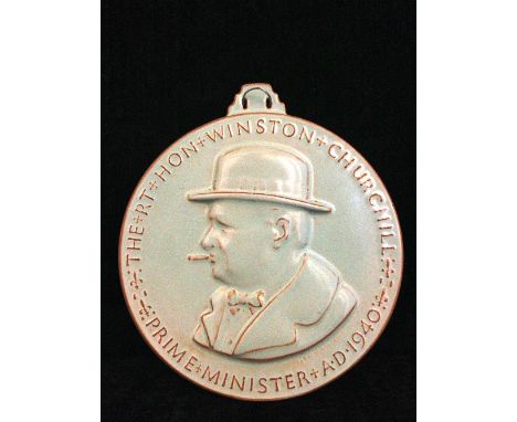 A Poole Pottery pale green glazed commemorative rondel dedicated to Winston Churchill after a design by Harry Parr, decorated