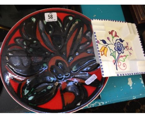 A Poole Pottery Delphis dish, shape 4, decorated in an abstract pattern on red ground together with a white bodied ashtray.