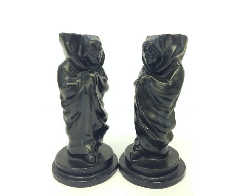 A pair of Poole Pottery Carter and Co black glazed stoneware candlesticks modelled as monks, the design attributed to Joseph 