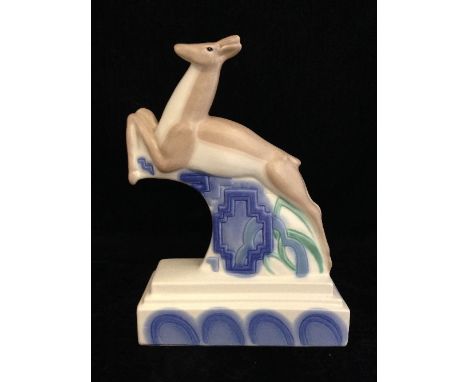 A Poole Pottery Studio Leaping Gazelle bookend, circa 1998, decorated in tones of blue and green on magnolia ground by Nikki 