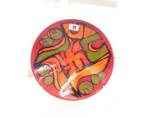 A Poole Pottery Delphis dish, shape 57, decorated in an abstract pattern on red ground by Cynthia Bennett.