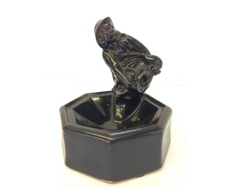A Poole Pottery Carter Stabler Adams octagonal brown glazed ashtray modelled as a fisherman holding a grotesque fish, impress