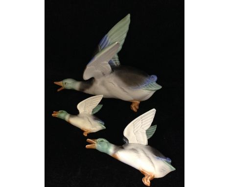 A graduated set of three Poole Pottery Flying Ducks, designed by John Adams, circa 1936-39, assisted by Harry Brown, airbrush
