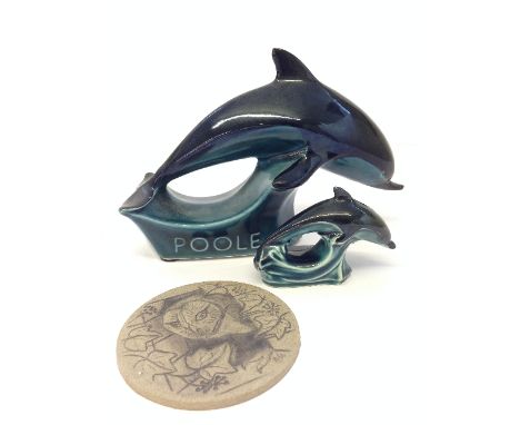 A miniature Poole Pottery blue glazed Dolphin together with a blue glazed advertising Dolphin and a stoneware rondel decorate