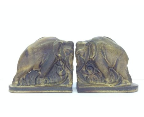 A pair of Poole Pottery Carter Stabler Adams brown glazed earthenware elephant bookends designed by Harold Brownsword, circa 