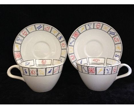A pair of Poole Pottery Fortune Telling teacups and saucers designed by Ian Messiter.