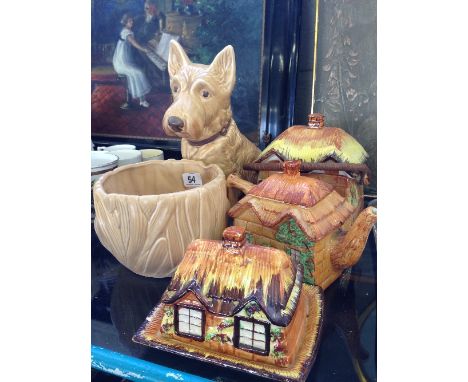A large brown glazed Sylvac china dog, 1209 together with a plant pot (4132) and three Cottage Ware china items.