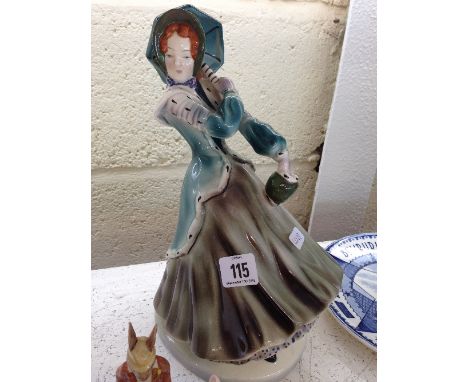 A Goldscheider U.S.A. Art Deco china figure modelled as a young lady in winter clothing with bonnet and umbrella, printed and