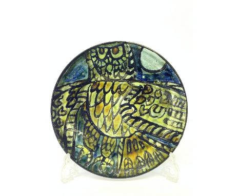 A Poole Pottery Studio plate, attributed to a design by Tony Morris, decorated with a stylised Owl with outstretched wings in