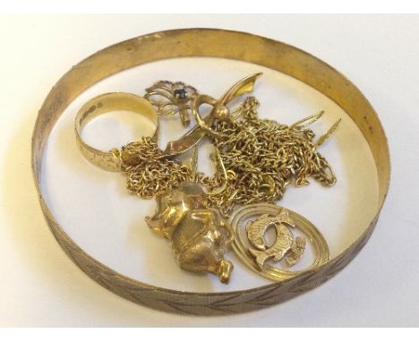 A mixed lot of 9 carat gold including a bangle (9.3 grams) and other gold items together with an 18 carat gold wedding band.